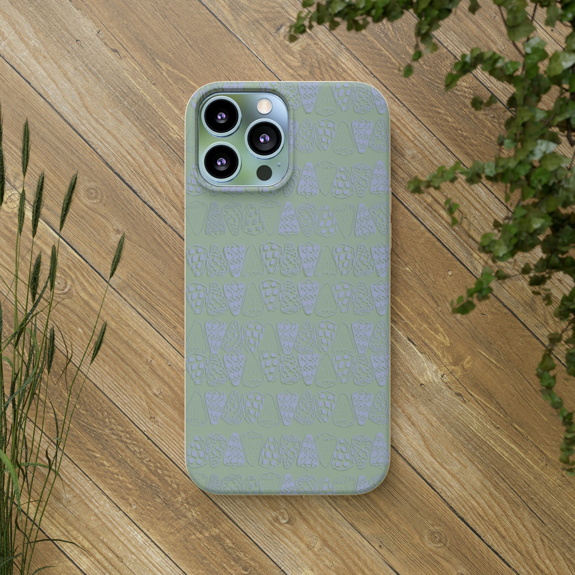 Sage green biodegradable phone case with blue cone shell design