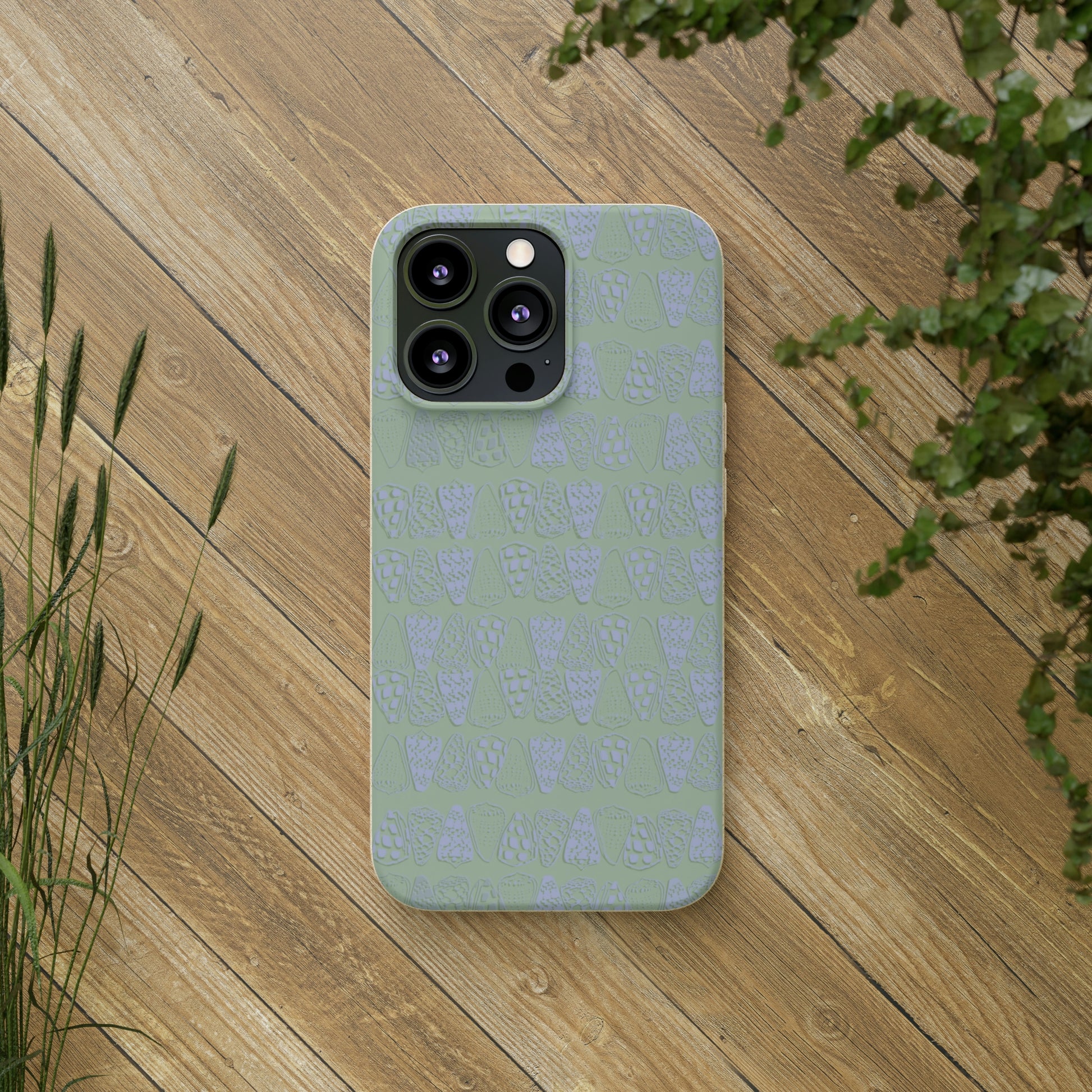 Sage green biodegradable phone case with blue cone shell design