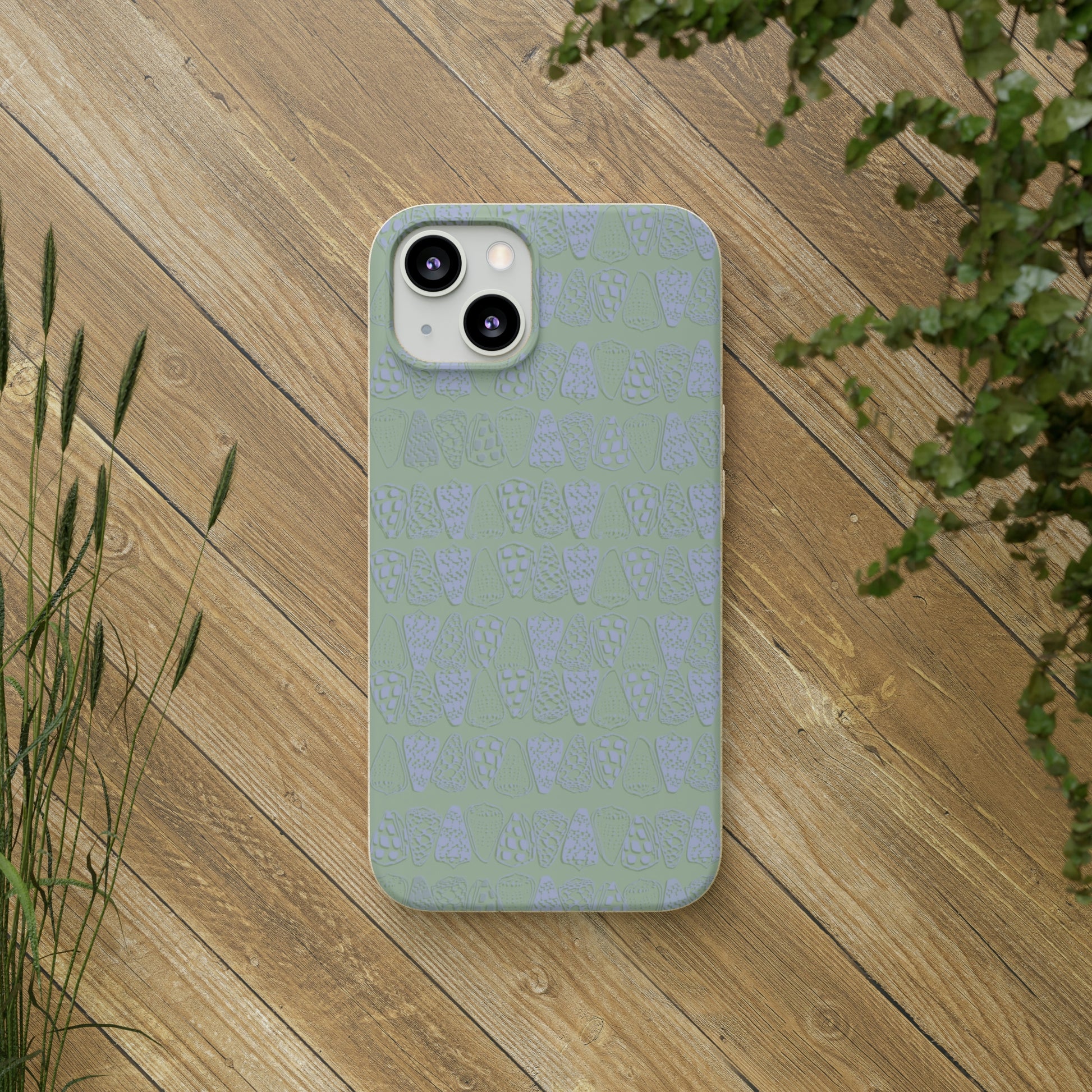 Sage green biodegradable phone case with blue cone shell design